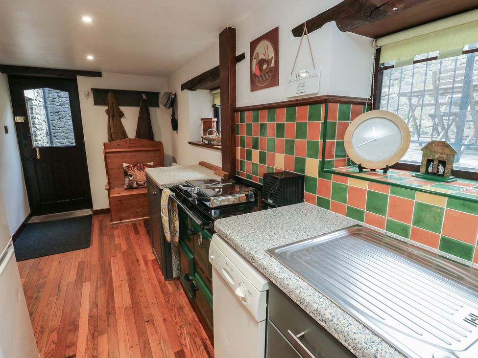 A kitchen with a door and counters at Bradshaw House in Hope Valley