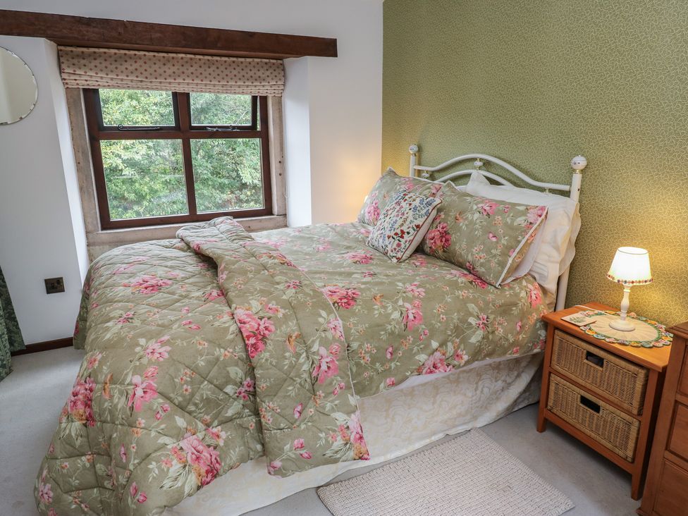 A bedroom with a bed and window at Bradshaw House in Hope Valley