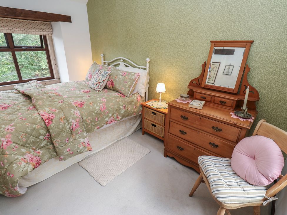 A bedroom with a bed and dresser at Bradshaw House in Hope Valley