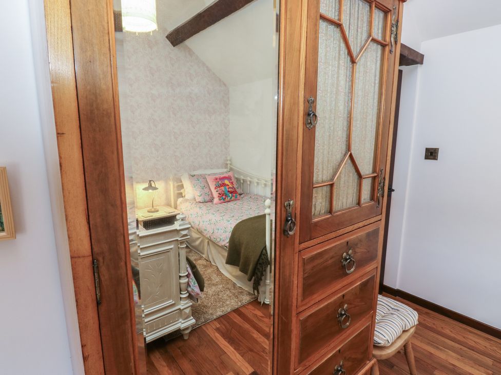 A bedroom with a bed and wardrobe at Bradshaw House in Hope Valley