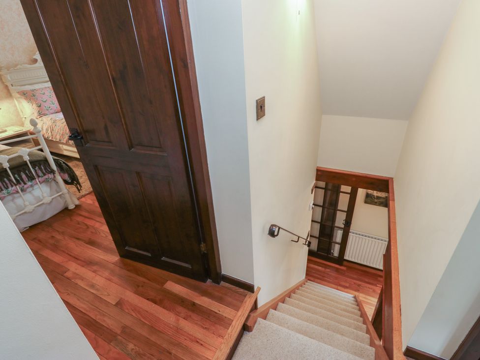 A staircase leading down with a door frame at Bradshaw House in Hope Valley