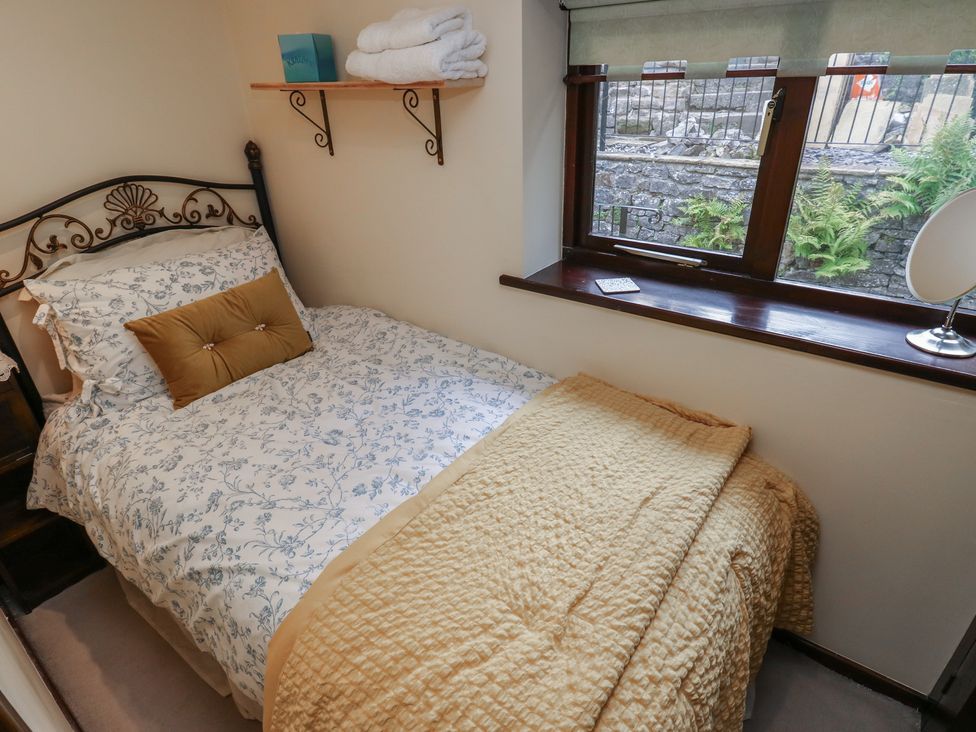 A bedroom with bed and towels on a shelf at Bradshaw House in Hope Valley