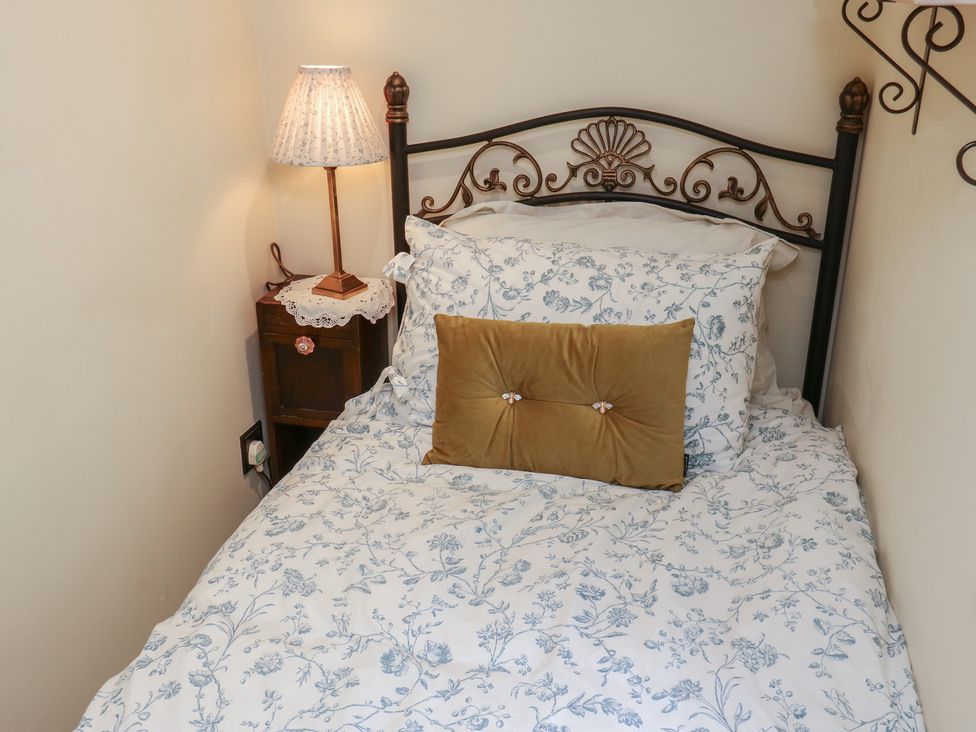A bedroom with a bed and lamp at Bradshaw House in Hope Valley