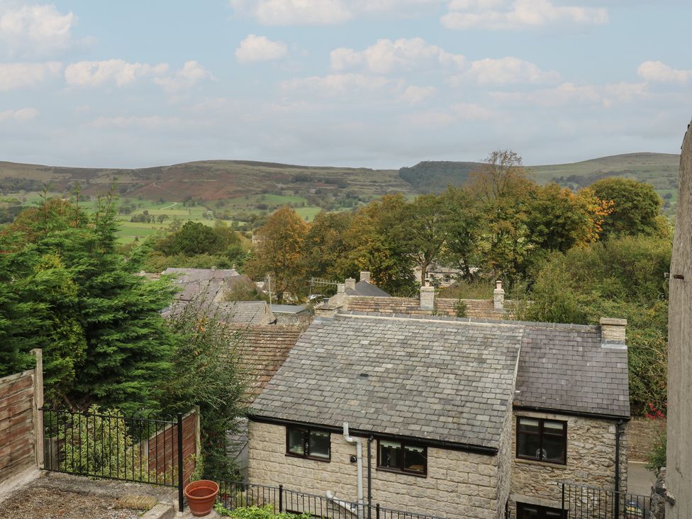 A view of houses and trees with mountains in the background at Bradshaw House Hope Valley