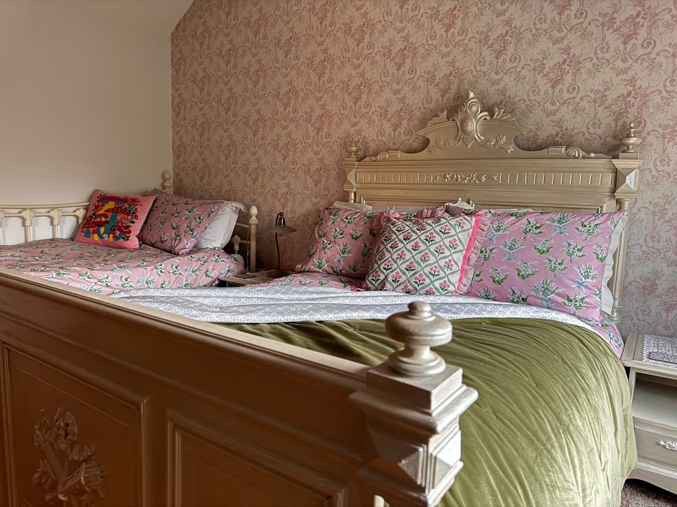 A bedroom with beds and decorative pillows at Bradshaw House in Castleton, Peak District