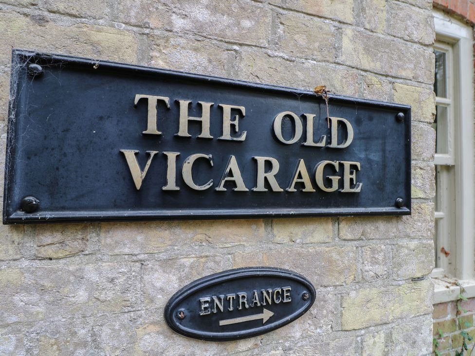 A sign displaying the name The Old Vicarage and an entrance indicator