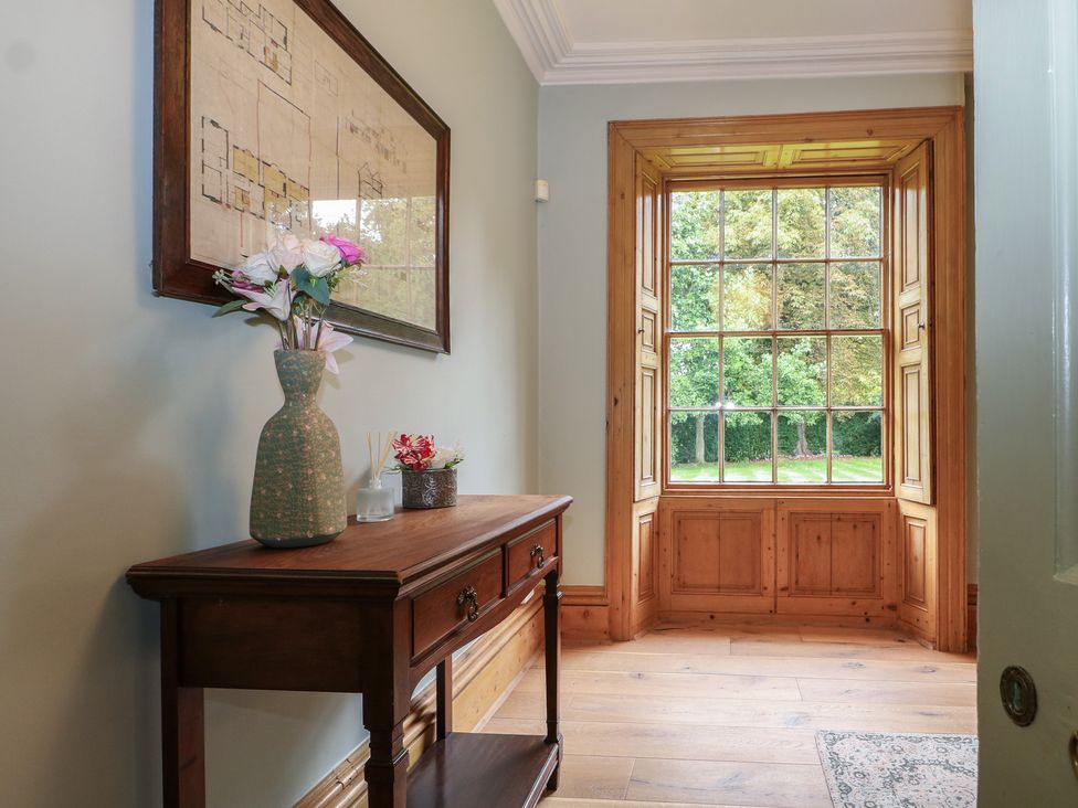 A hallway with a window and a table at Old Vicarage