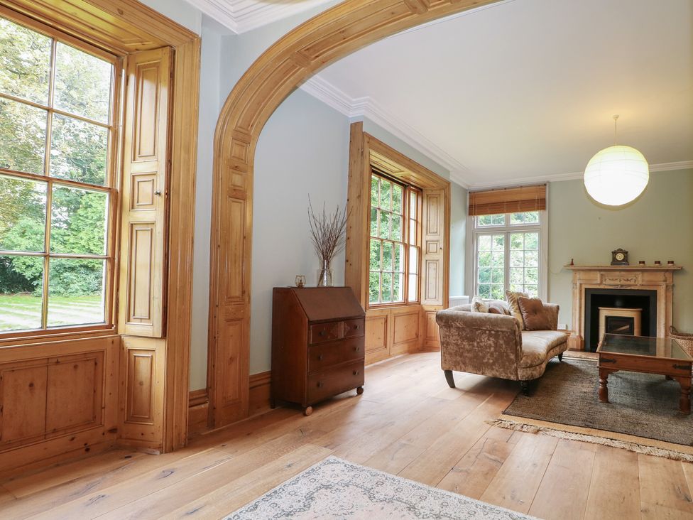 A living room with a sofa and fireplace at Old Vicarage