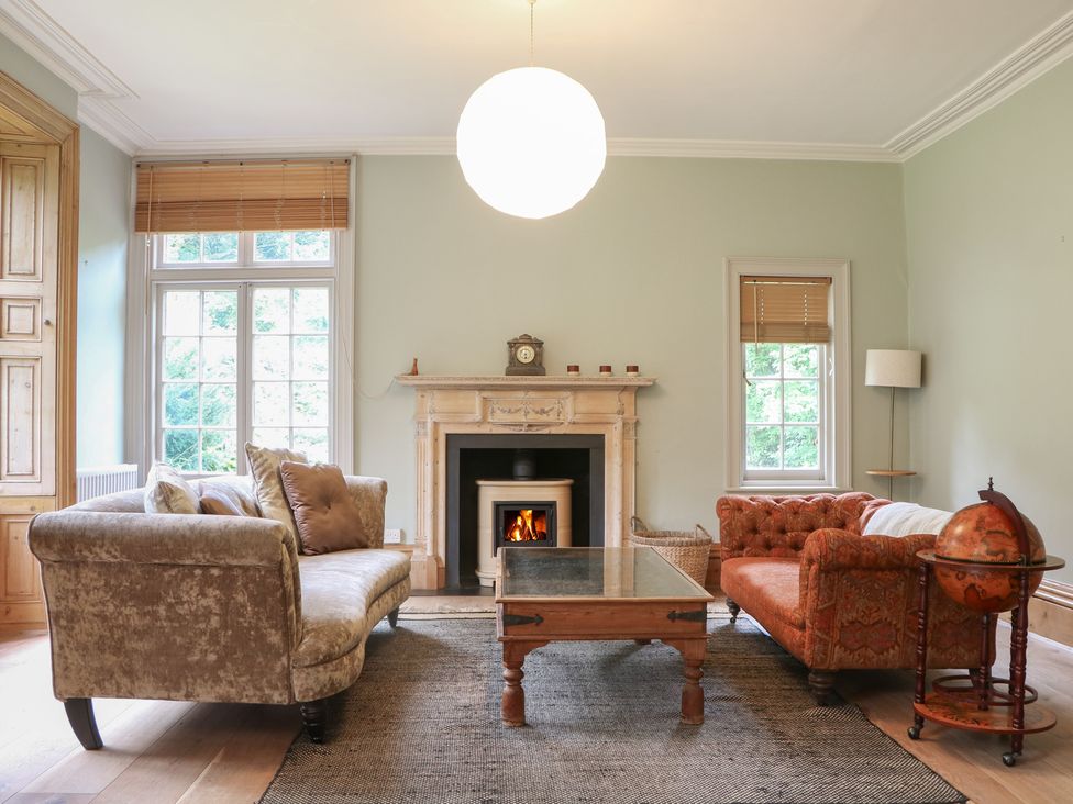 A living room with a fireplace and couch at Old Vicarage