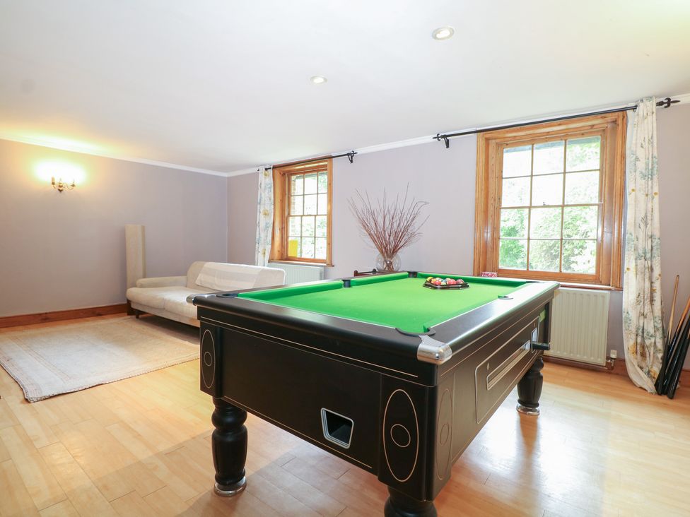 A game room with a billiards table and a sofa at Old Vicarage