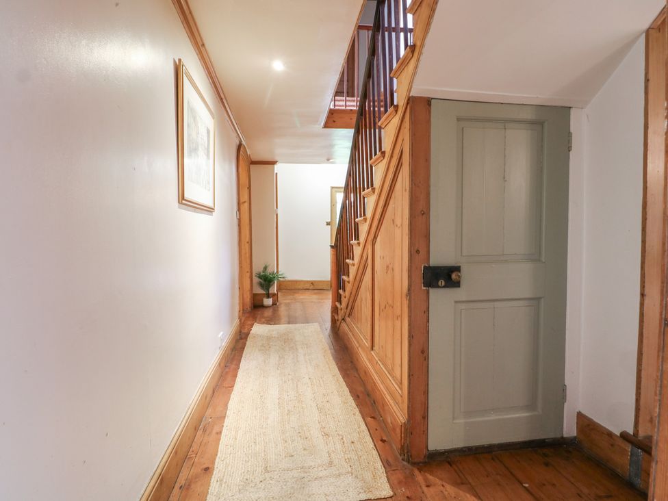 A hallway with a staircase and a door at The Old Vicarage 