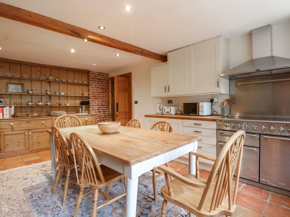 A kitchen with a wooden table and chairs at Old Vicarage
