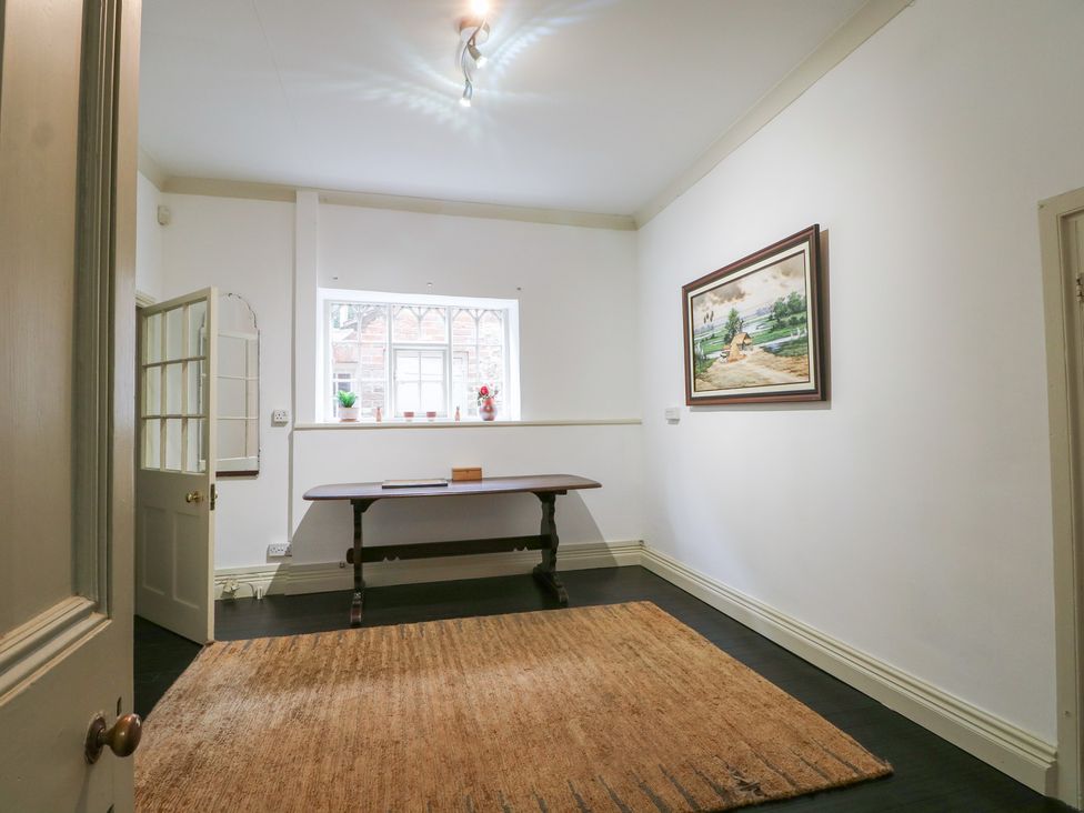 A hallway with a table and painting at Old Vicarage
