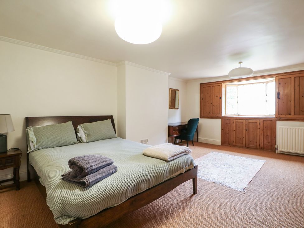A bedroom with a bed and desk at Old Vicarage in 
