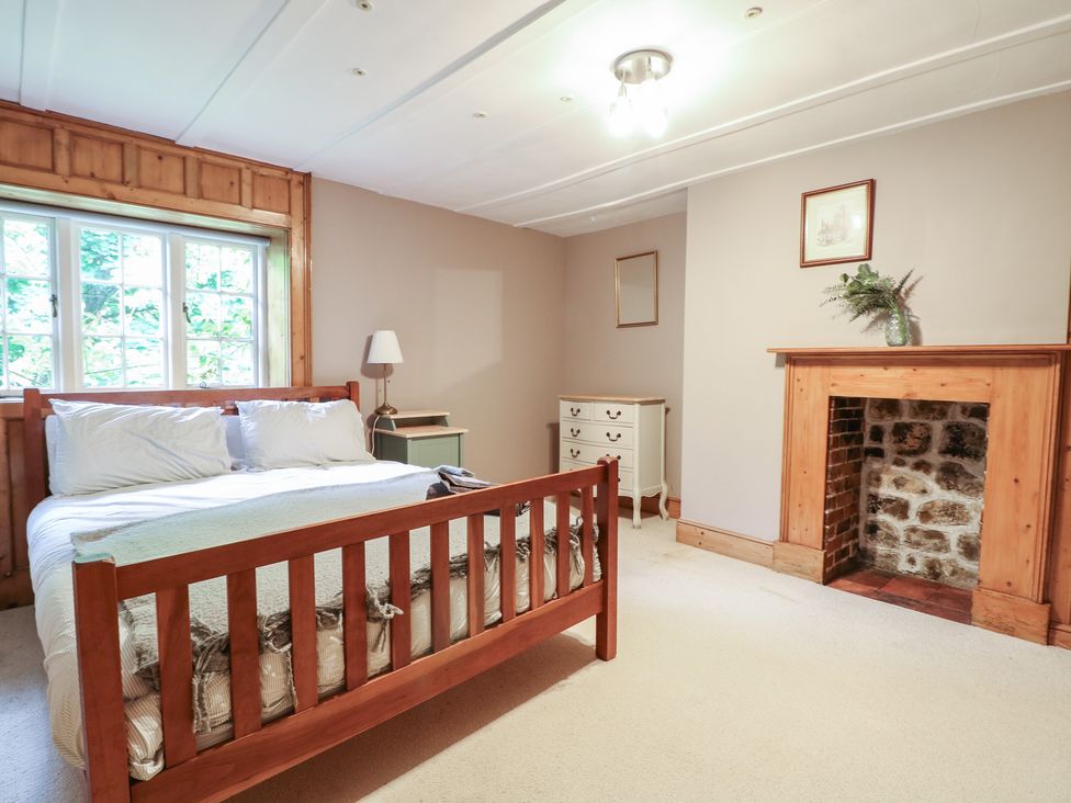 A bedroom with a bed and dresser at Old Vicarage
