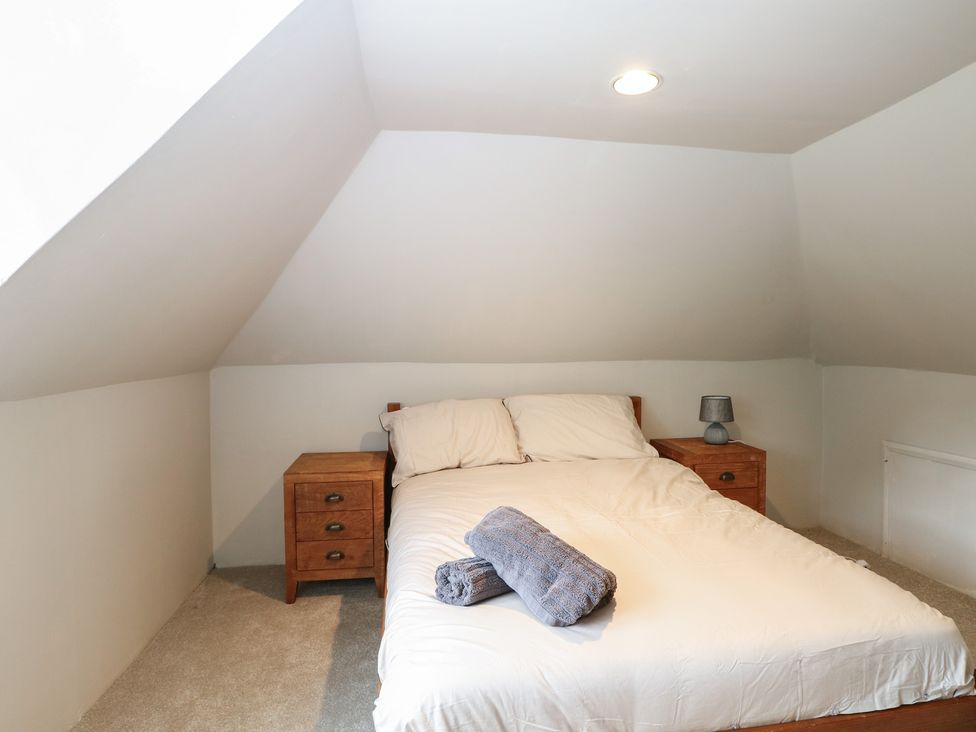 A bedroom with a bed and bedside tables at Old Vicarage