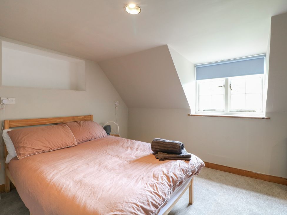 A bedroom with a bed, pillows, and towels at Old Vicarage in 