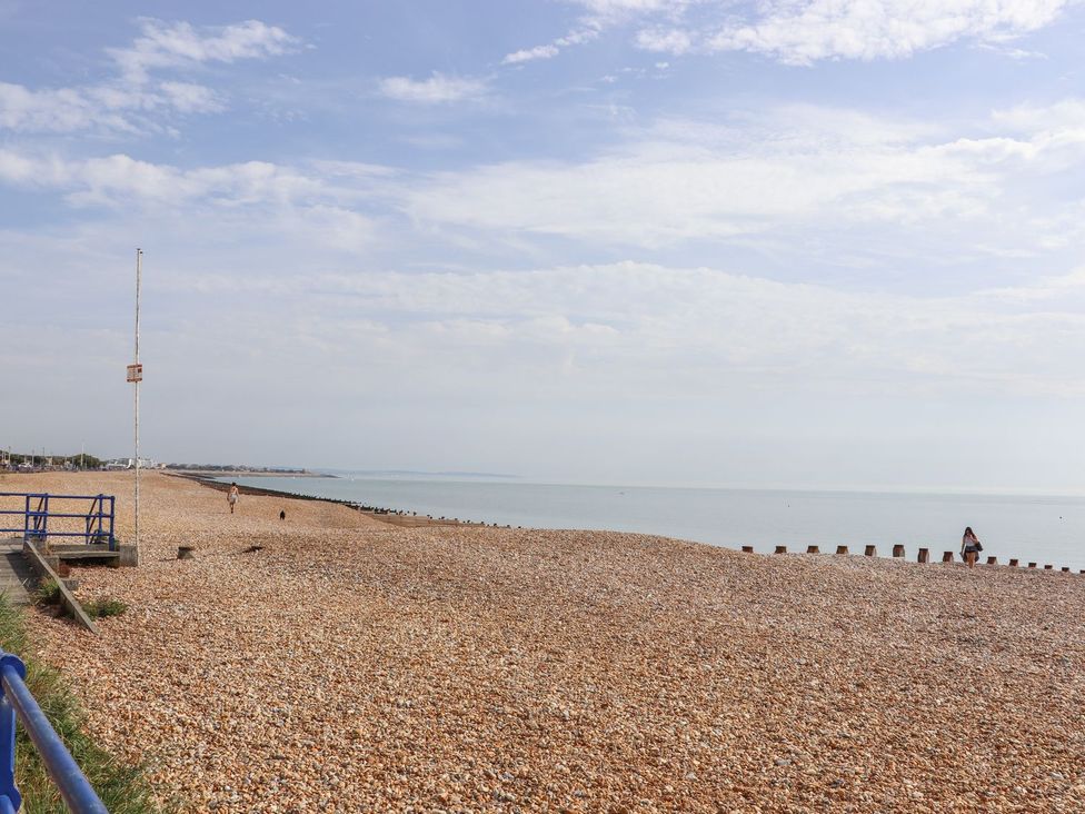 A beach with pebbles and people at Pebbles in Eastbourne