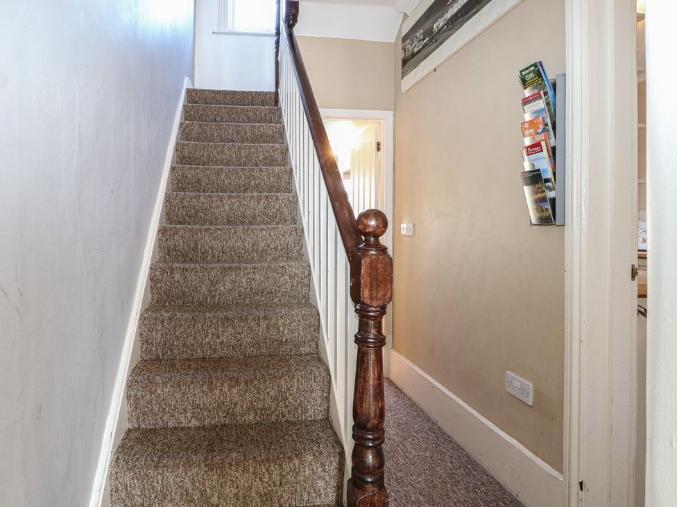 A staircase leading to a hallway at Pebbles Eastbourne