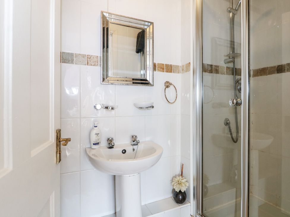 A bathroom with a shower and sink at Pebbles Eastbourne