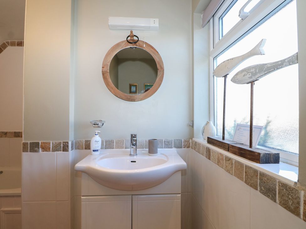 A bathroom with a sink and mirror at Pebbles in Eastbourne