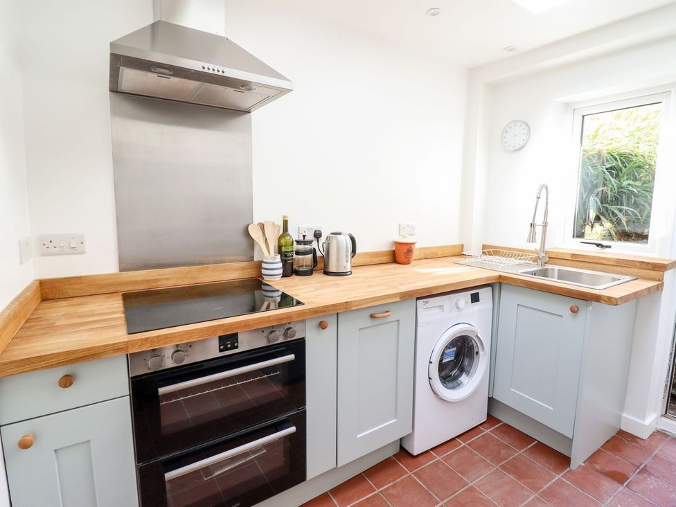 A kitchen with appliances and a sink at Haulfryn Dolwyddelan