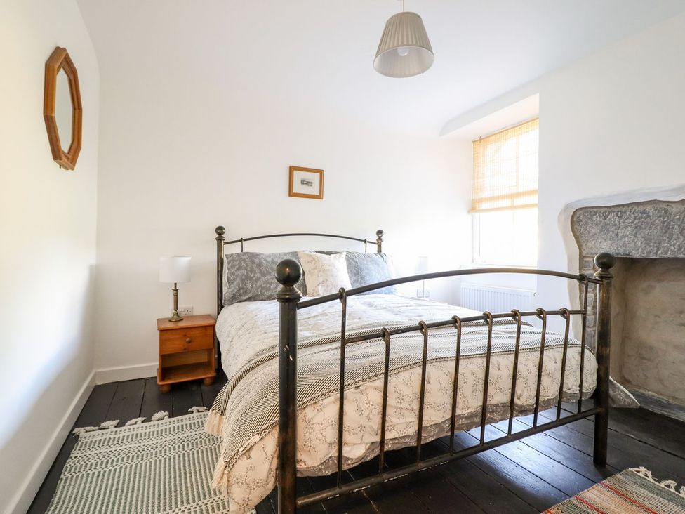 A bedroom with a bed and nightstand at Haulfryn in Dolwyddelan