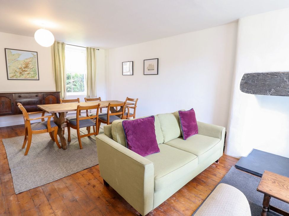 A living room with a sofa and dining table at Haulfryn in Dolwyddelan