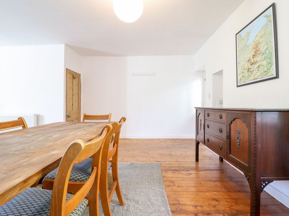 A dining room with a table and chairs at Haulfryn in Dolwyddelan