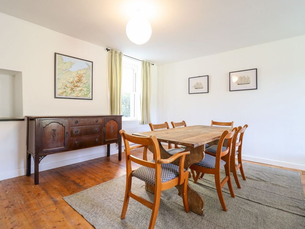 A dining room with a wooden table and chairs at Haulfryn in Dolwyddelan