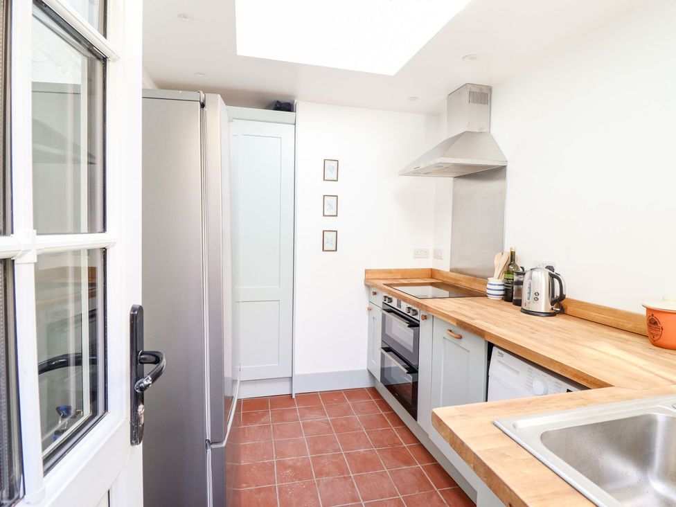 A kitchen with a refrigerator, oven, and sink at Haulfryn in Dolwyddelan