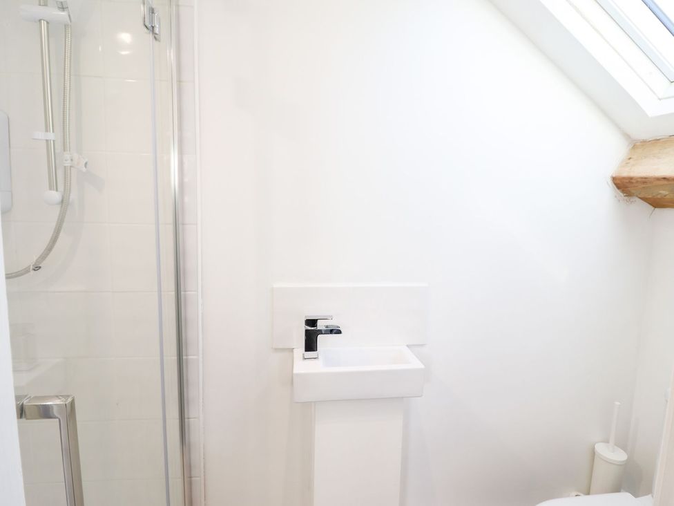 A bathroom featuring a shower, sink, and toilet at Haulfryn in Dolwyddelan