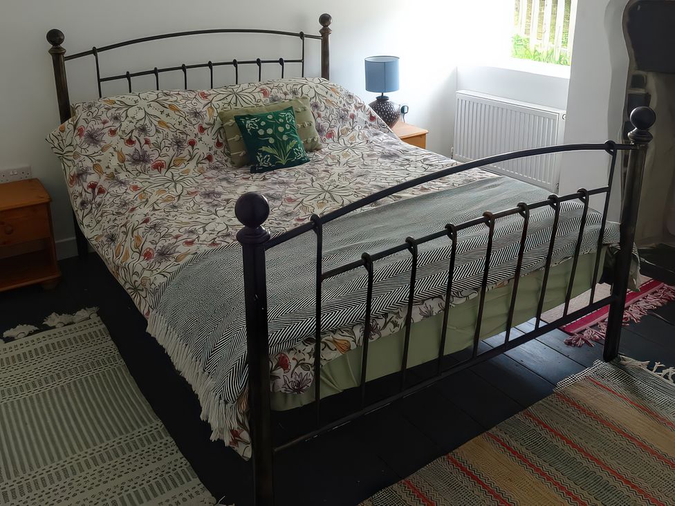 A bedroom with a bed and nightstand at Haulfryn in Dolwyddelan