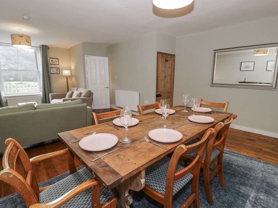 A dining room with a wooden table and chairs at Haulfryn in Dolwyddelan