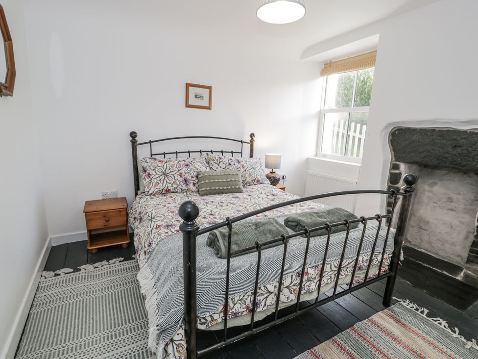 A bedroom with a bed and nightstand at Haulfryn, Dolwyddelan