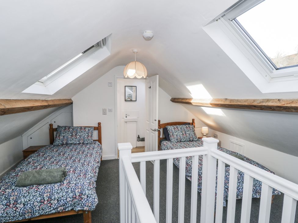 A bedroom with two beds and a skylight at Haulfryn Dolwyddelan