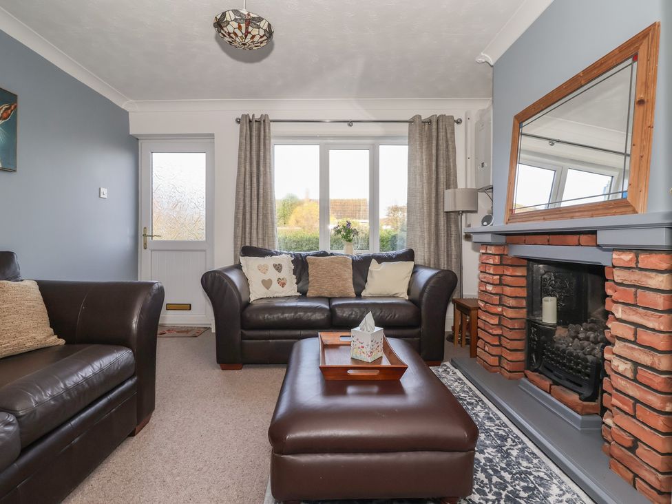 A living room with a sofa and coffee table at Forget Me Not Cottage in Hull