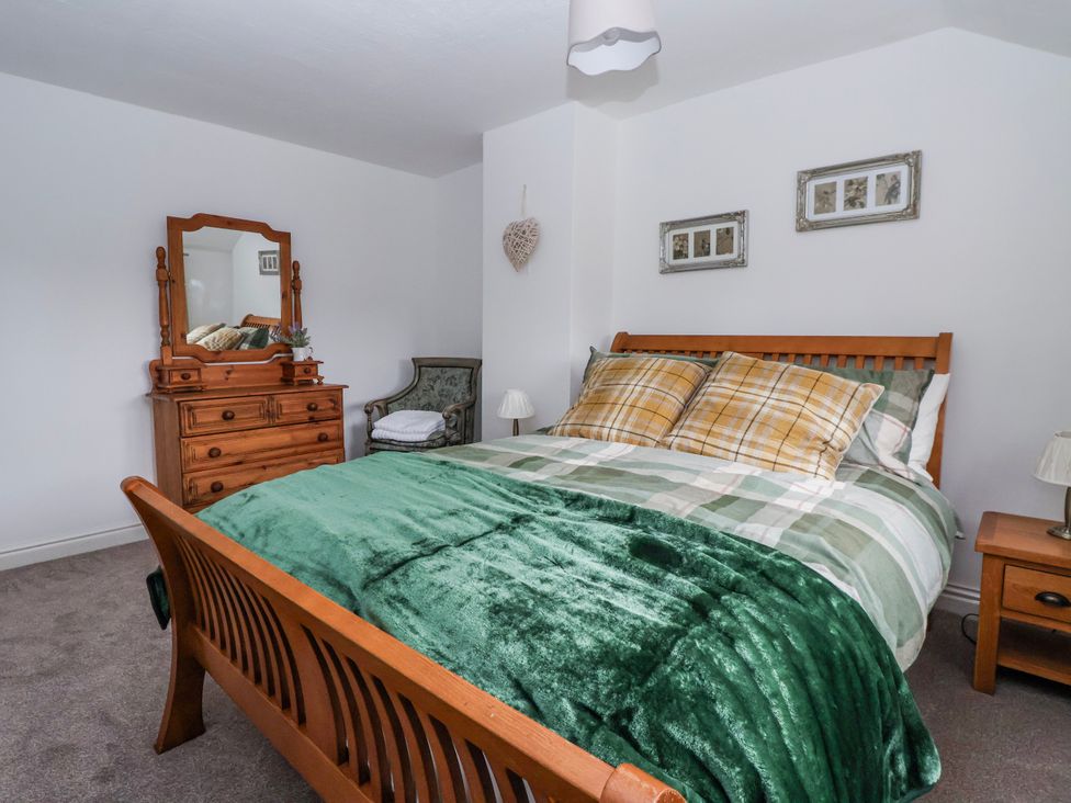 A bedroom with a bed and dresser at Forget Me Not Cottage Roos