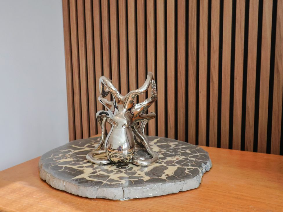 A sculpture of an octopus on a display stand at Arum in Portland Bill