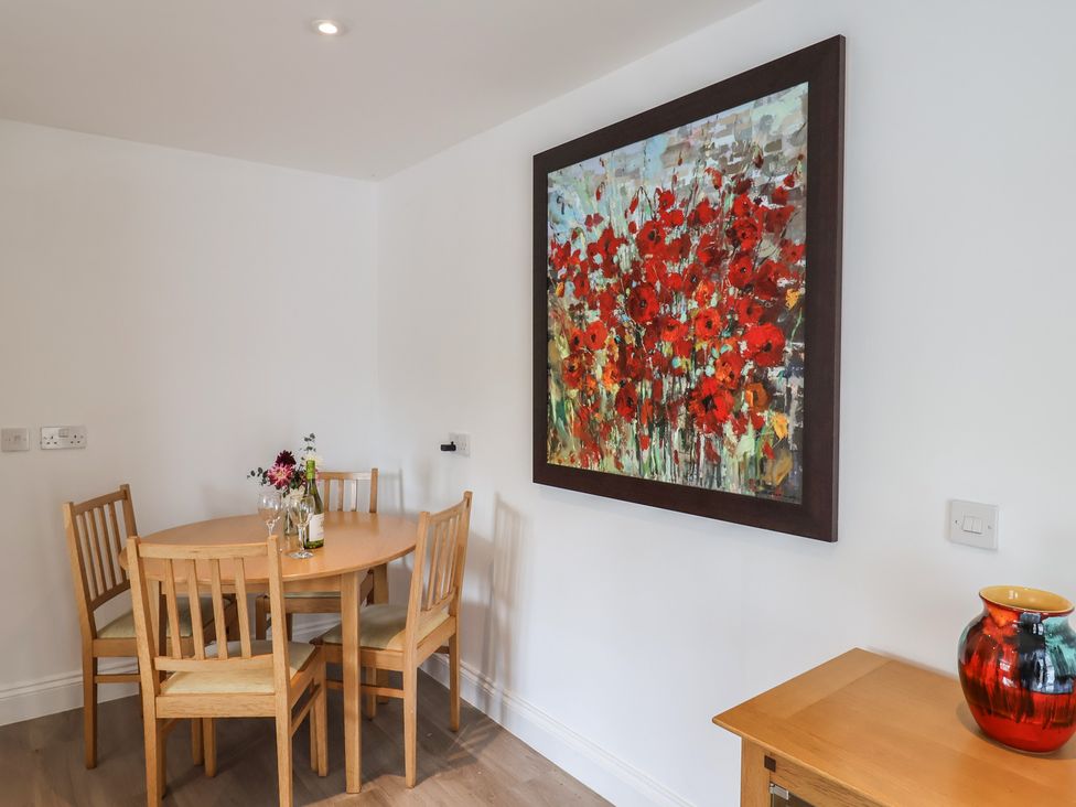 A dining room with a table and chairs at Arum Portland Bill