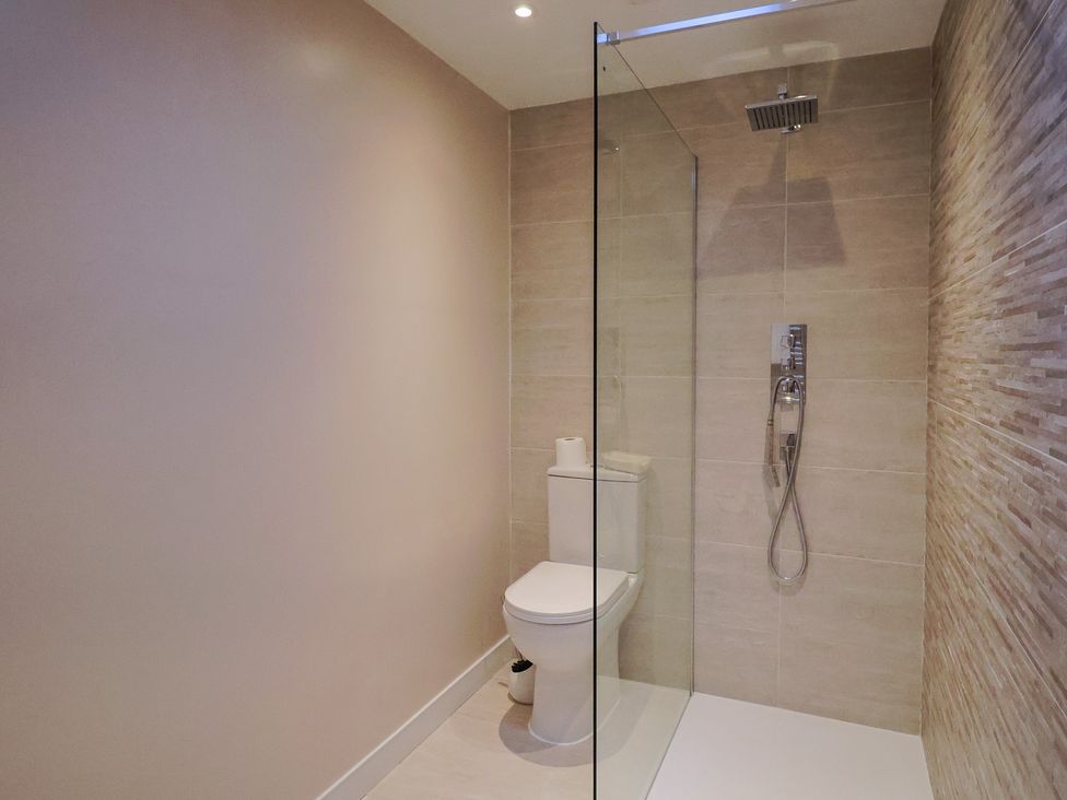 A bathroom with a shower and toilet at Arum in Portland Bill