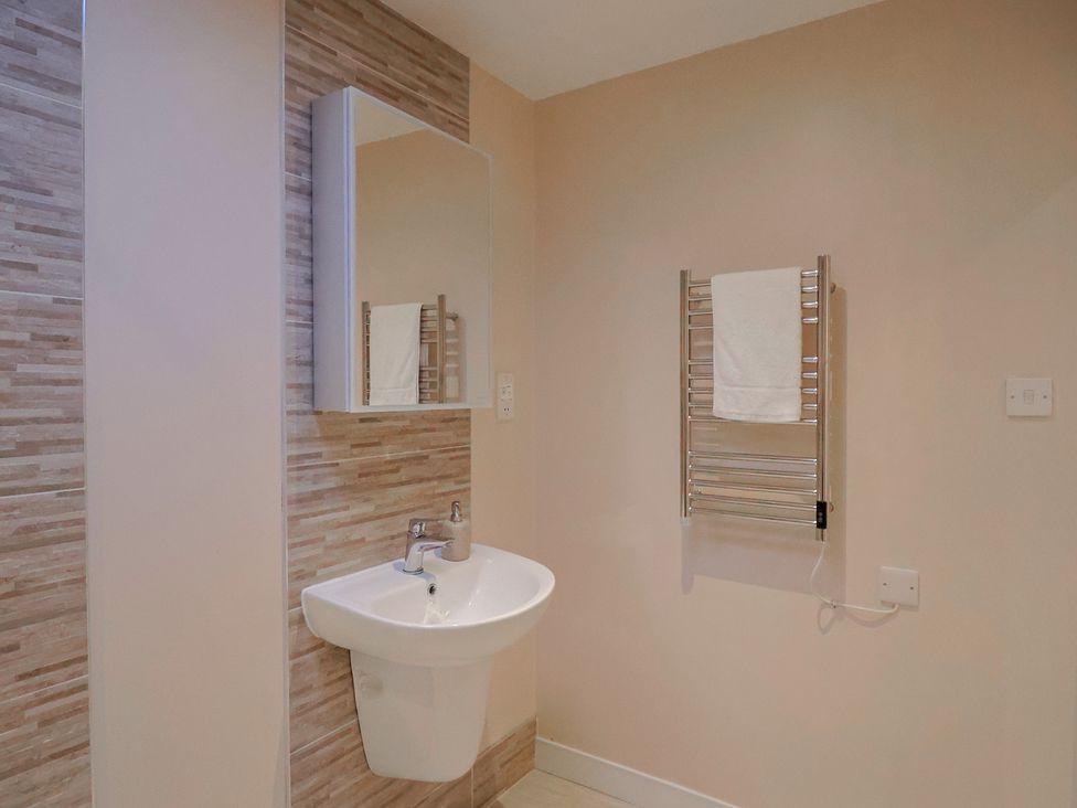 A bathroom featuring a sink and towel rail at Arum in Portland Bill