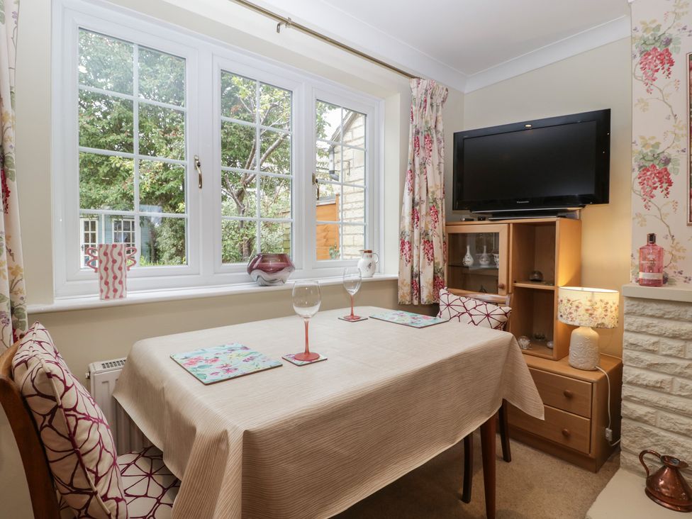 A dining room with a table and chairs at Evergreen in Broadway