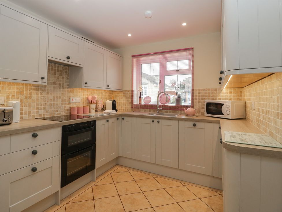 A kitchen with cabinets, sink, microwave and toaster at Evergreen in Broadway