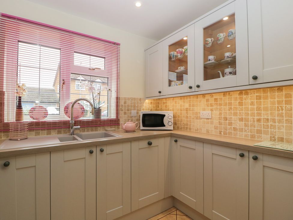 A kitchen with a sink and microwave at Evergreen in Broadway