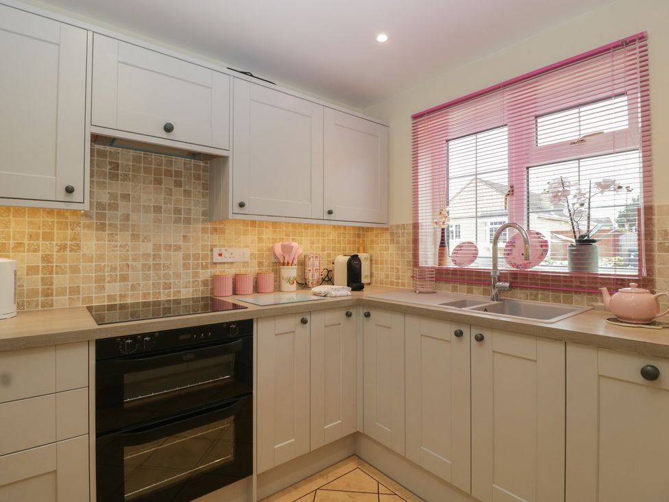 A kitchen with cabinets and a window at Evergreen in Broadway