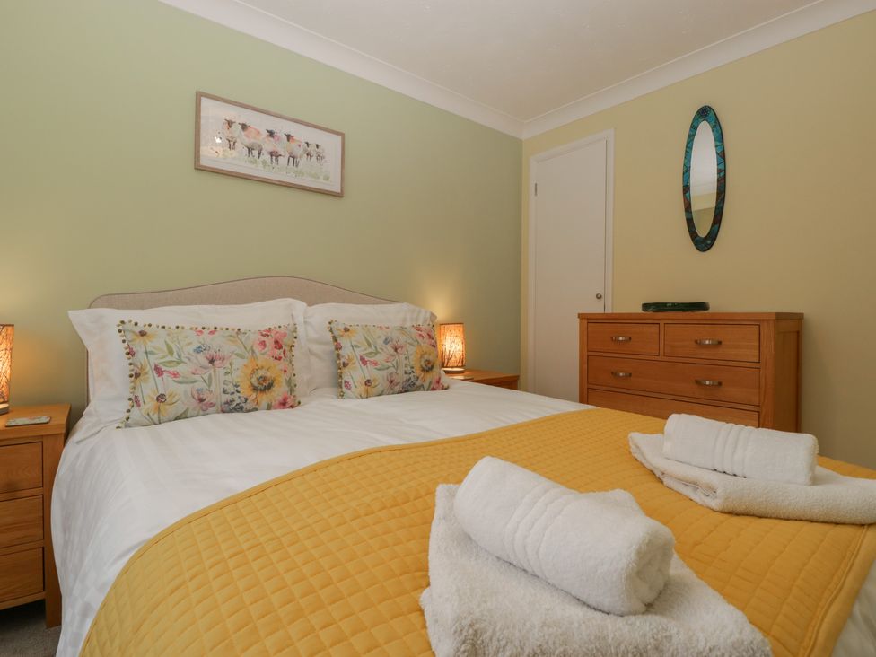 A bedroom with a double bed and dresser at Evergreen in Broadway