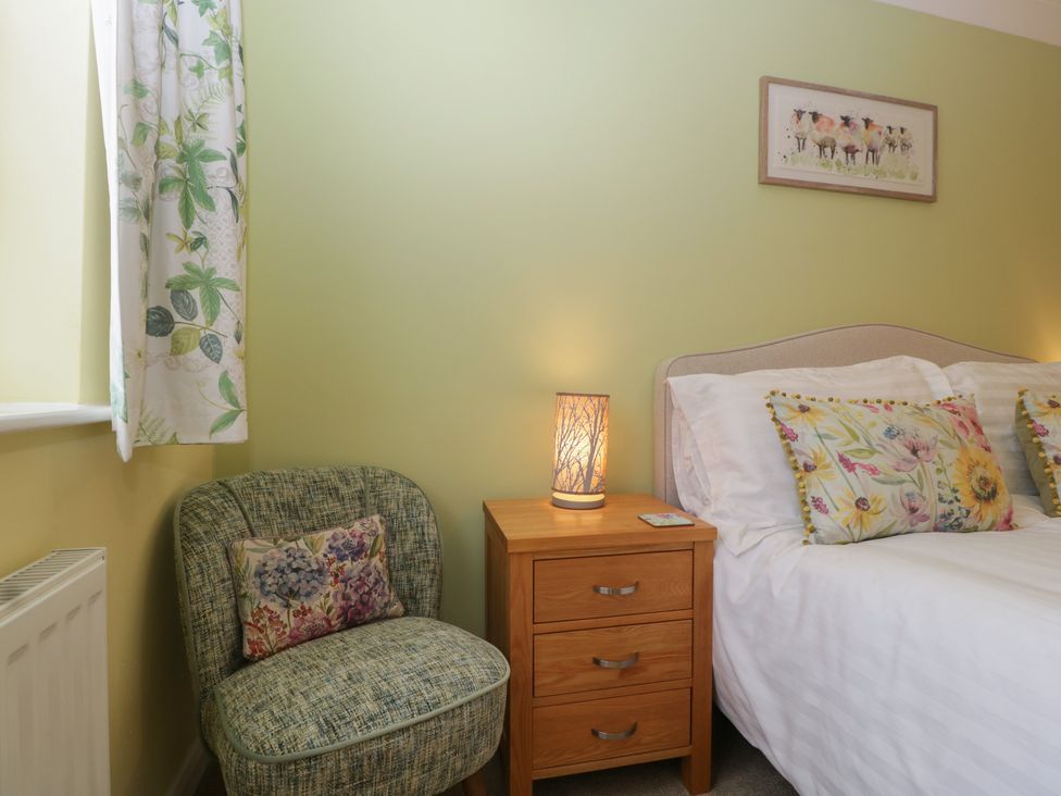 A bedroom with a bed and nightstand at Evergreen in Broadway