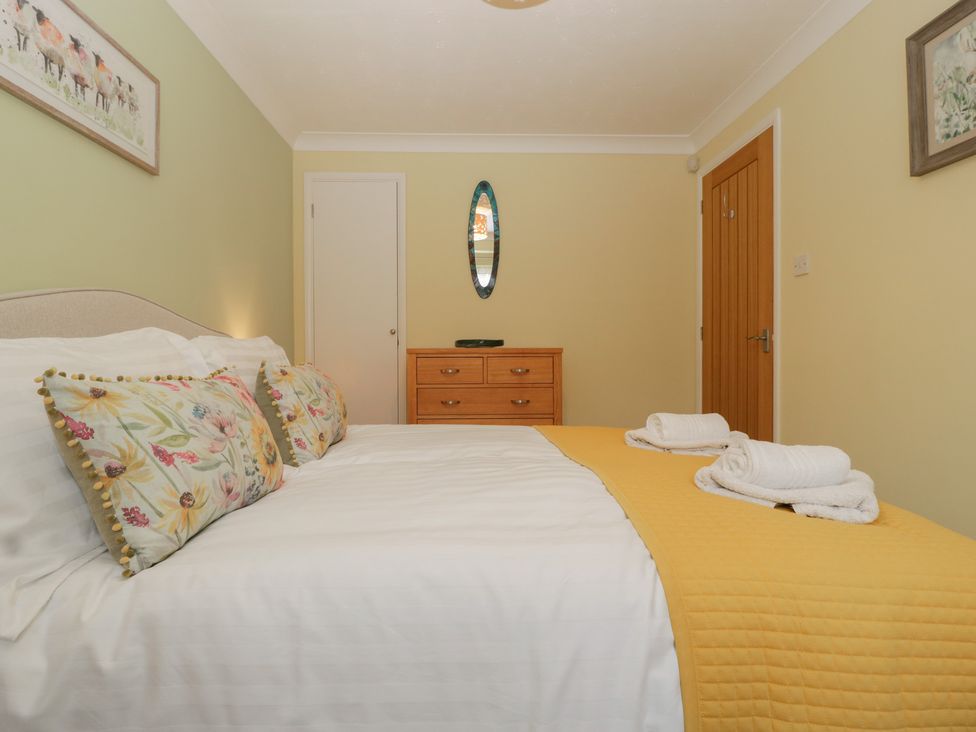 A bedroom with a bed and dresser at Evergreen in Broadway