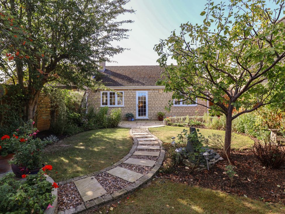 A garden with a pathway leading to a house at Evergreen in Broadway